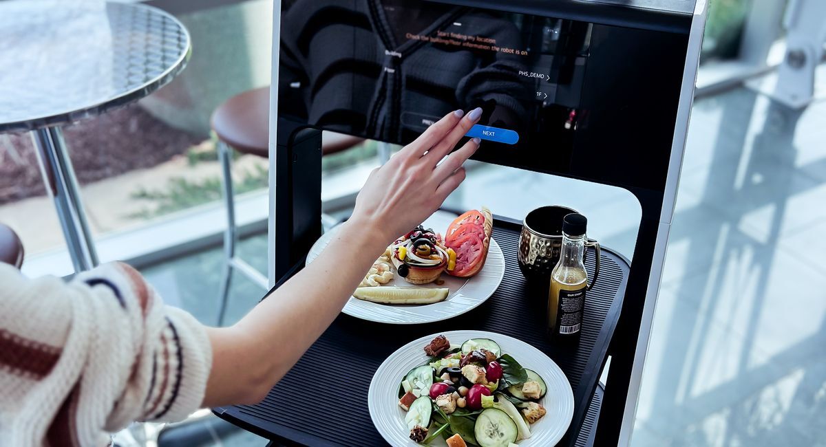 Placing an order with a restaurant's waiter robot.