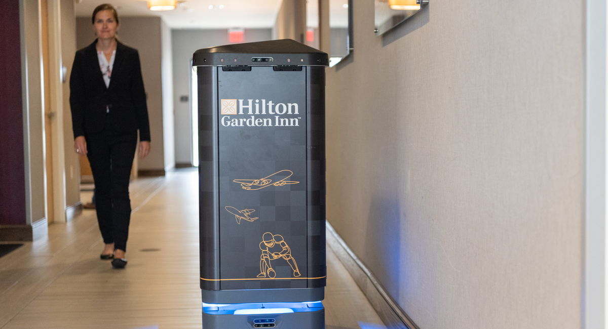 An autonomous robot delivering fresh linen to housekeeping staff.