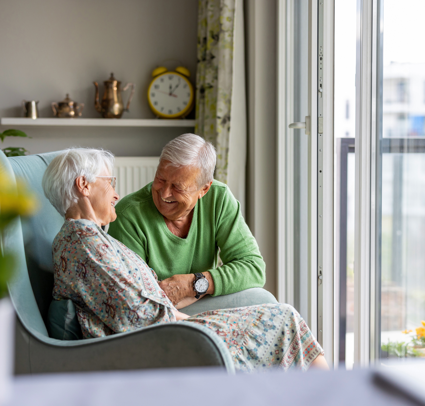 Senior couple in assisted living facility smiling at each other