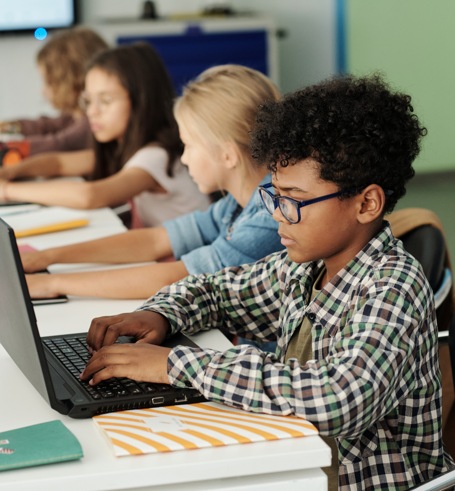 Four children learning using computers
